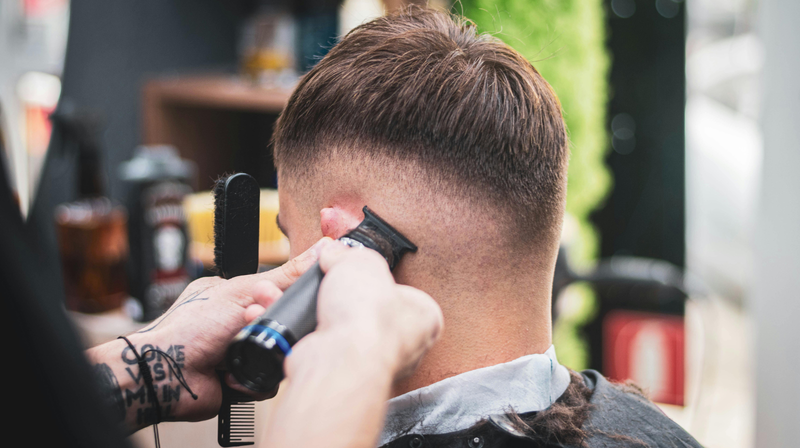 Barber giving a client a professional cut in a modern barbershop