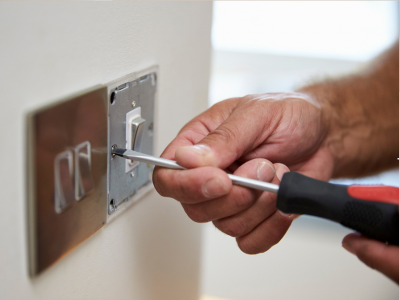 Electrician reviewing report on tablet